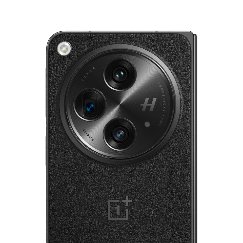 Black circular camera with three lenses on a sleek smartphone device.