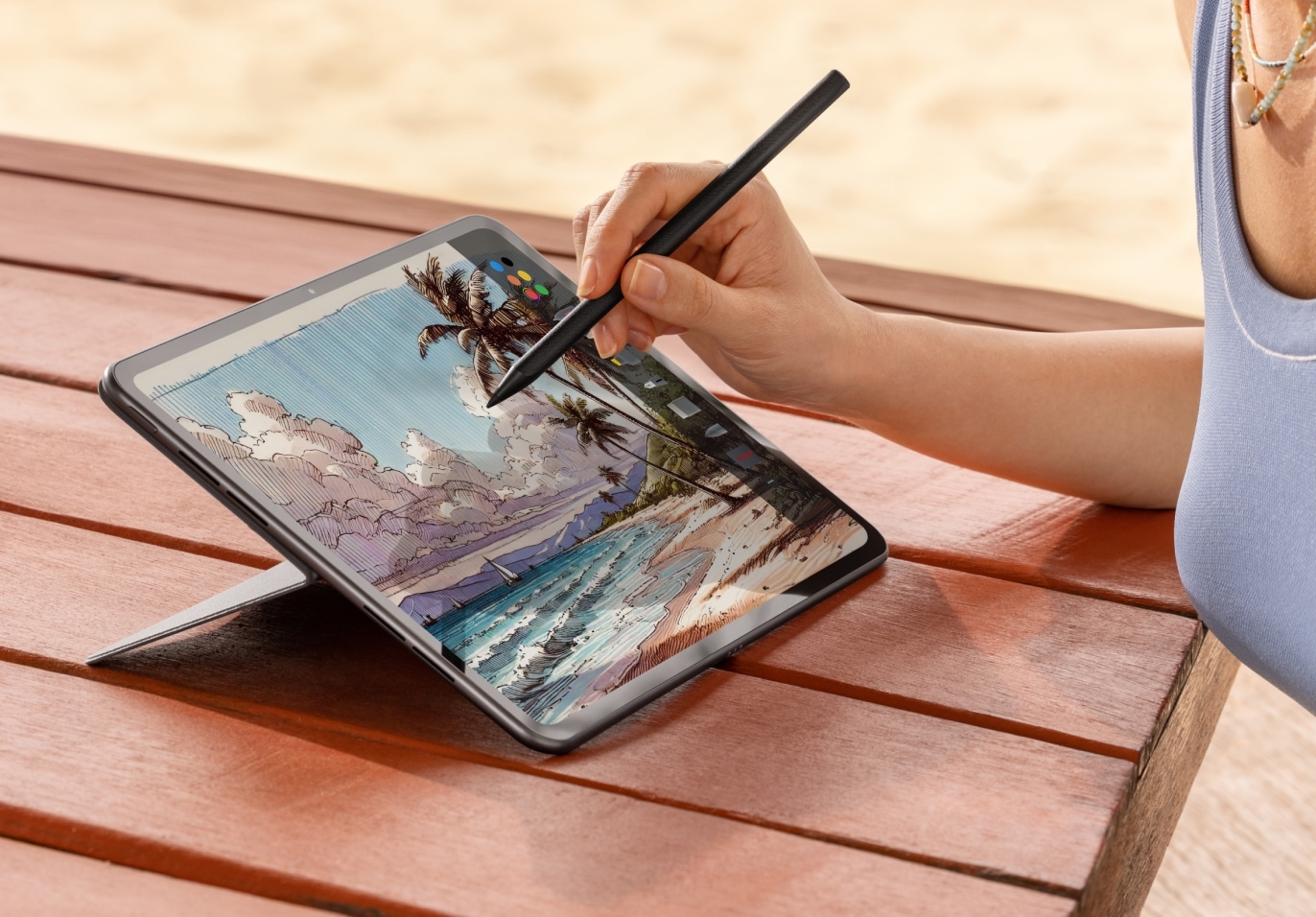 Colorful digital painting of tropical beach scene on tablet.