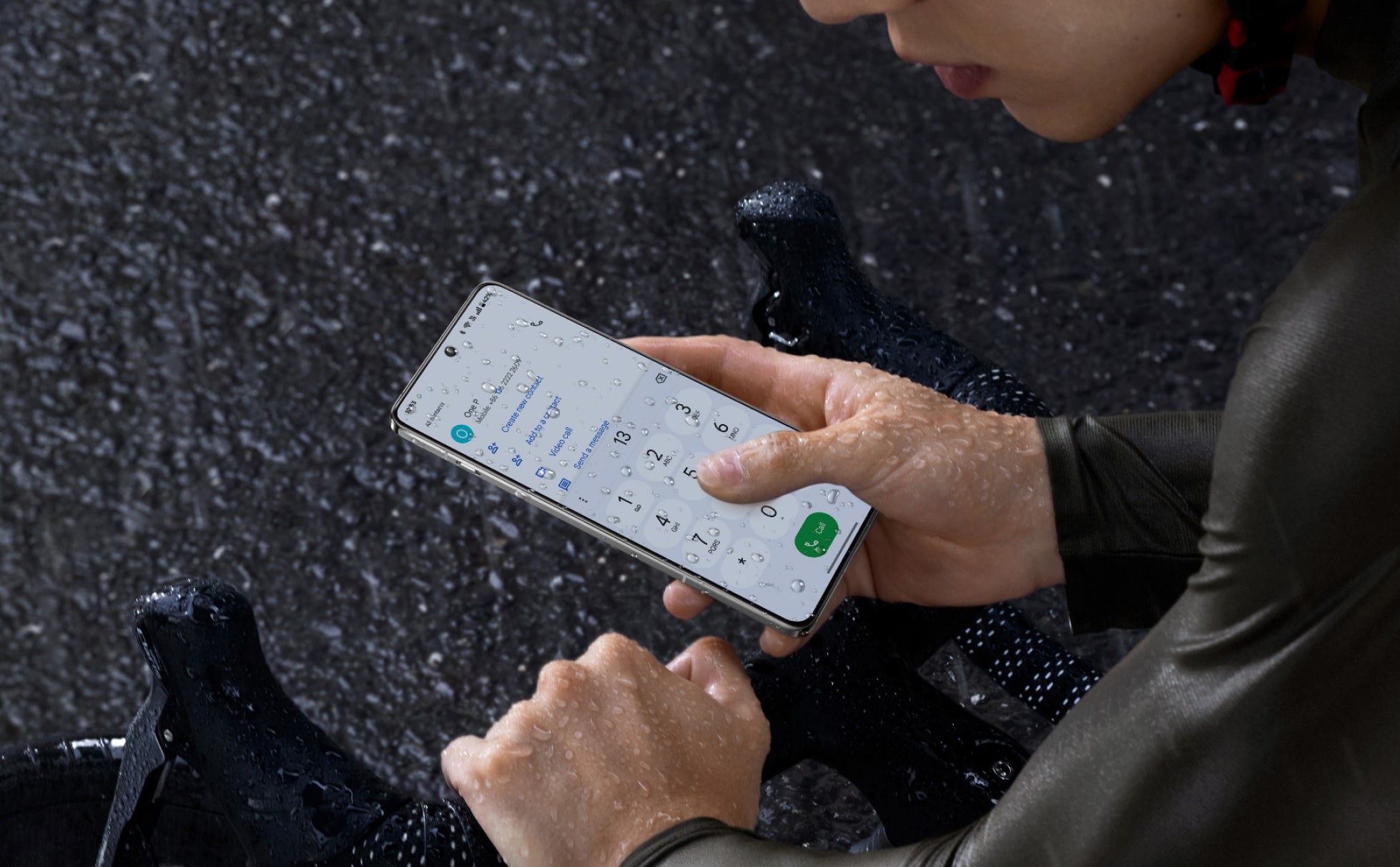 Hands holding a smartphone with a rainy, dark background.